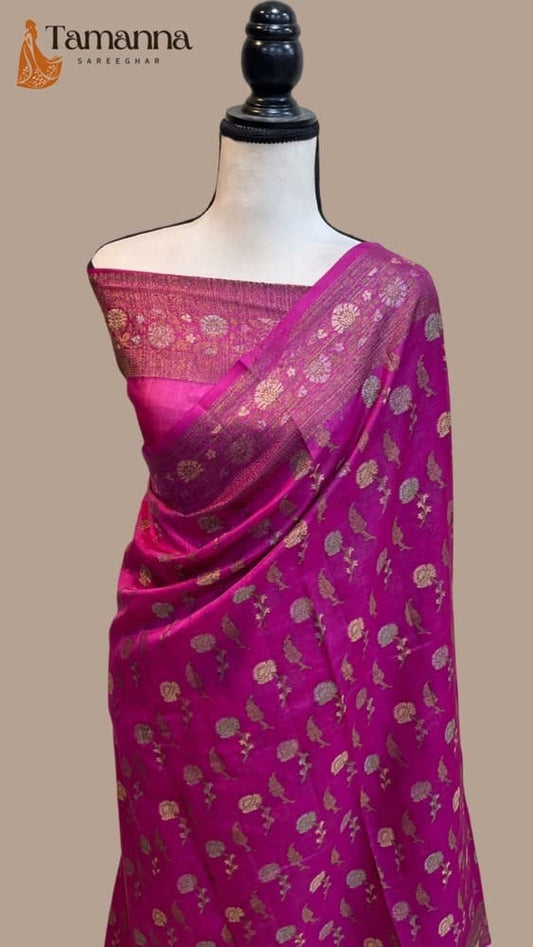 Magenta crepe Banarasi saree with gold-toned motif border and pallu on mannequin