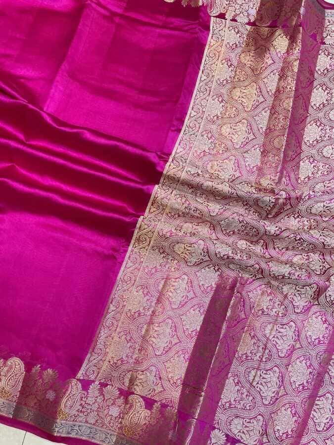 Hot pink saree border with gold-toned paisley motifs and textured weave detail