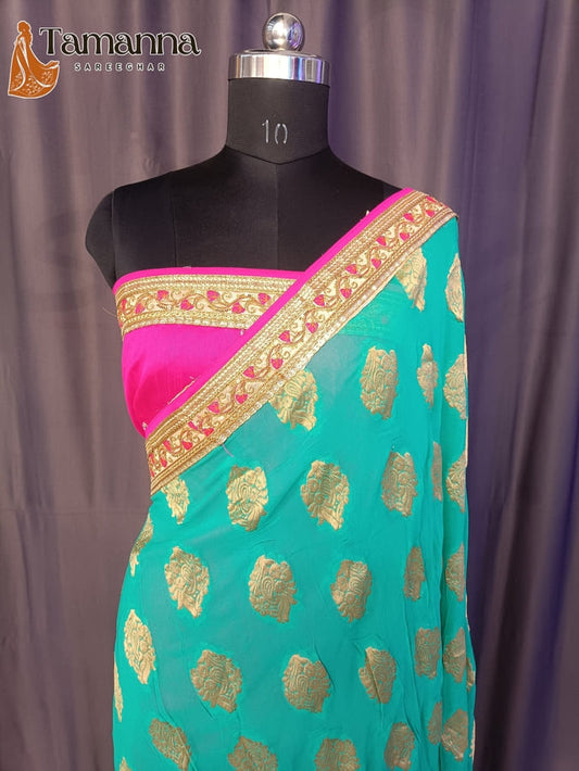 Half-and-half saree: teal body with gold motifs, pink border and pallu