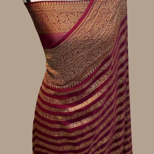 Maroon silk Banarasi saree with gold woven border and striped pallu