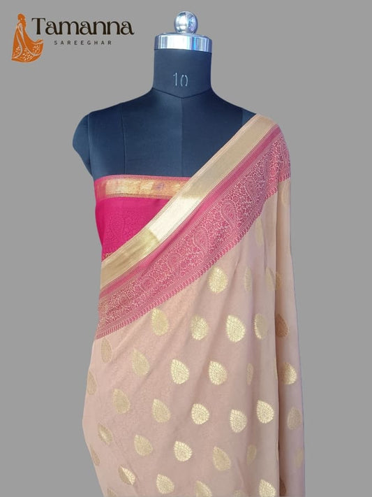 Light chiffon saree with gold dot motifs and pink-magenta border with gold edging
