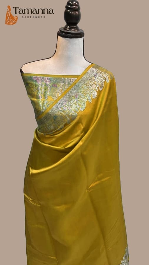 Yellow silk saree with silver-toned ornate border and contrast patterned pallu