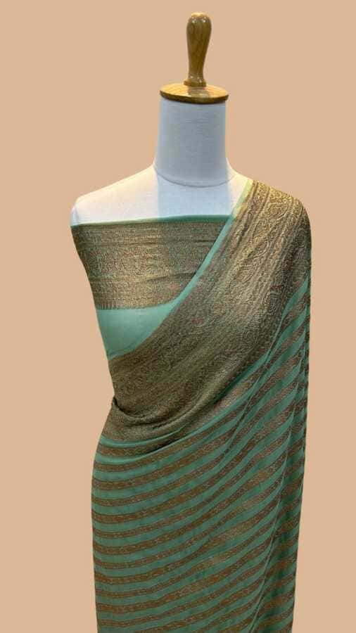 Teal silk saree with gold woven border and subtle striped pattern