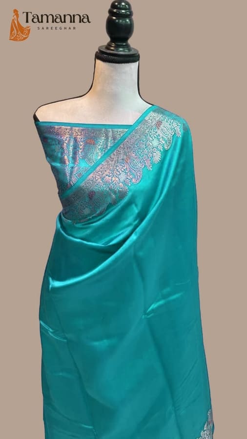 Teal silk banarasi saree with gold-toned woven border and patterned pallu
