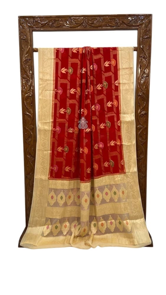 Red saree with cream border and patterned hem, gold motifs along the drape