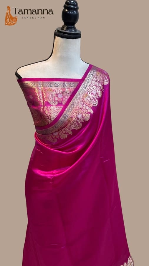 Hot pink silk saree with woven zari border and patterned pallu on mannequin