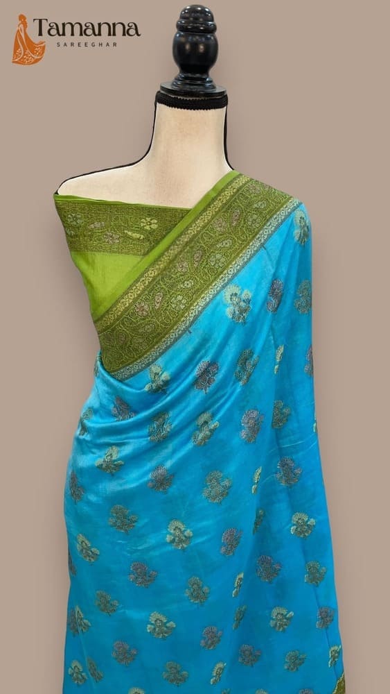 Banarasi saree on mannequin: turquoise with gold motifs, green border and pallu