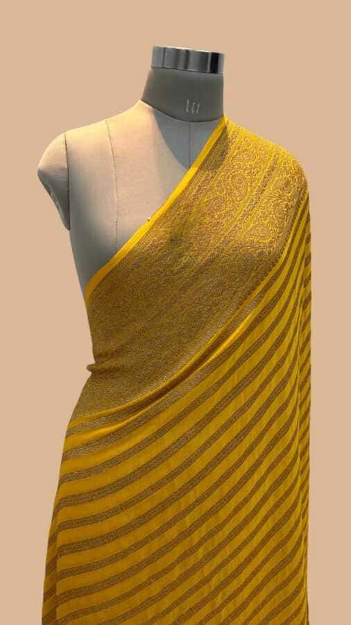 Turmeric yellow silk Banarasi saree with gold border and fine striped pallu