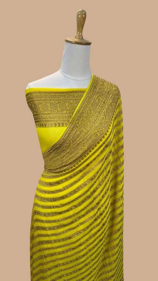 Yellow silk Banarasi sari with gold zari border and striped pallu