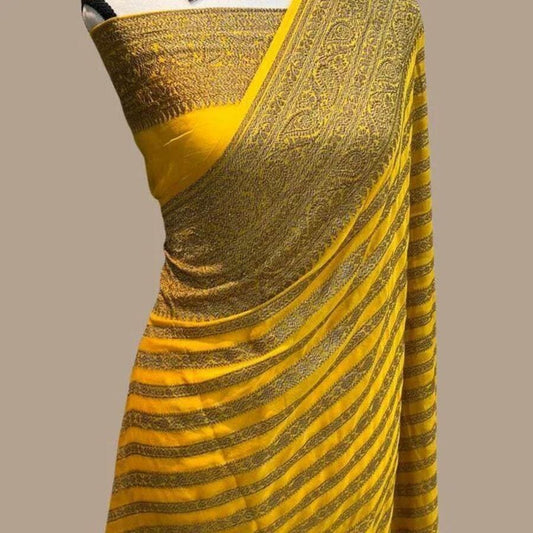 Mustard silk Banarasi saree with gold stripe border and woven motifs