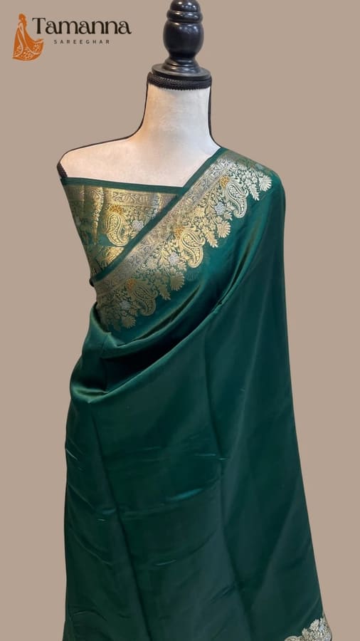 Green silk saree with wide gold paisley border and pallu drape