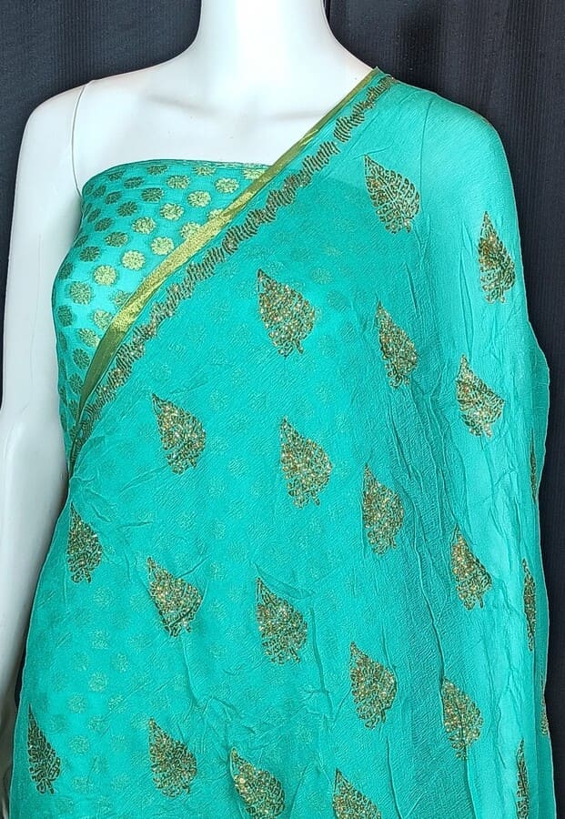 Turquoise chiffon saree with gold zari edging and scattered leaf motifs