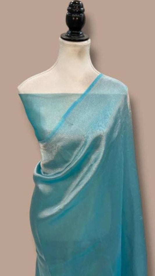 Teal Banarasi saree with bright blue pallu and silky drape on mannequin