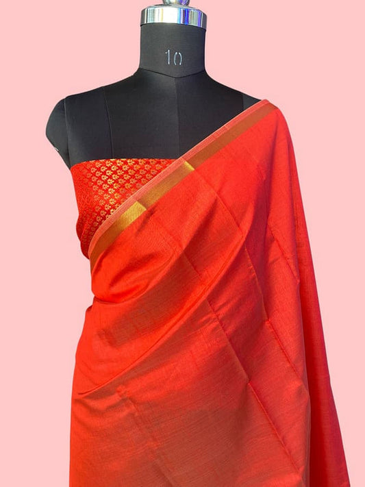 Red pure silk saree draped on mannequin with gold-trimmed pallu and pleated texture