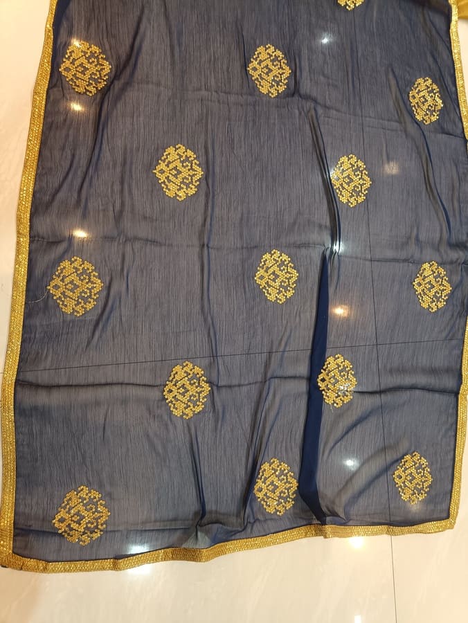Dark chiffon saree featuring gold sitara motifs and gold woven border