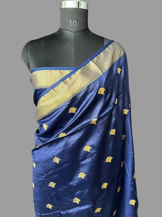 Draped blue silk saree with wide gold zari border and scattered gold motifs