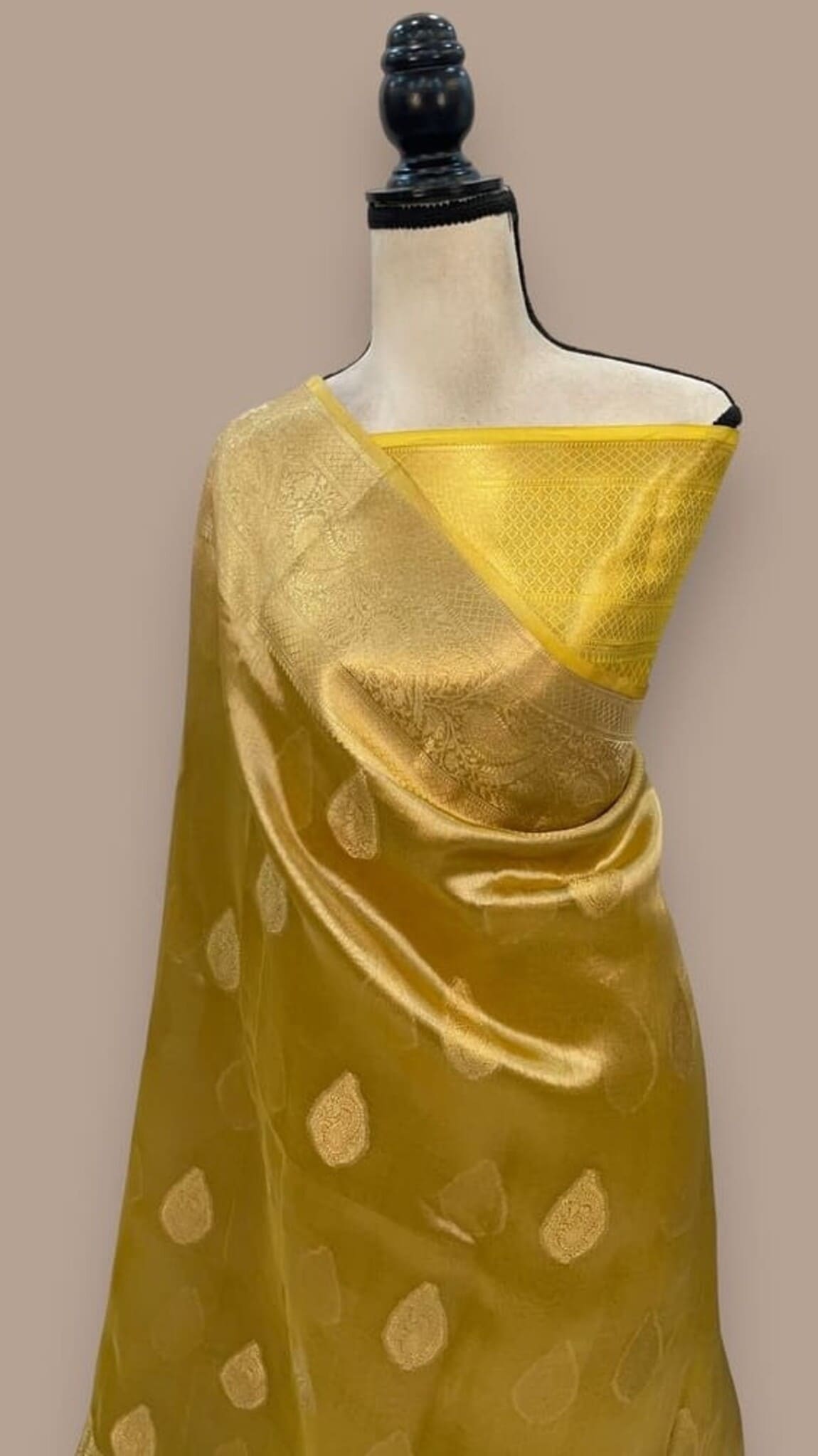Golden yellow Banarasi tissue saree with gold zari motifs and diagonal pallu border