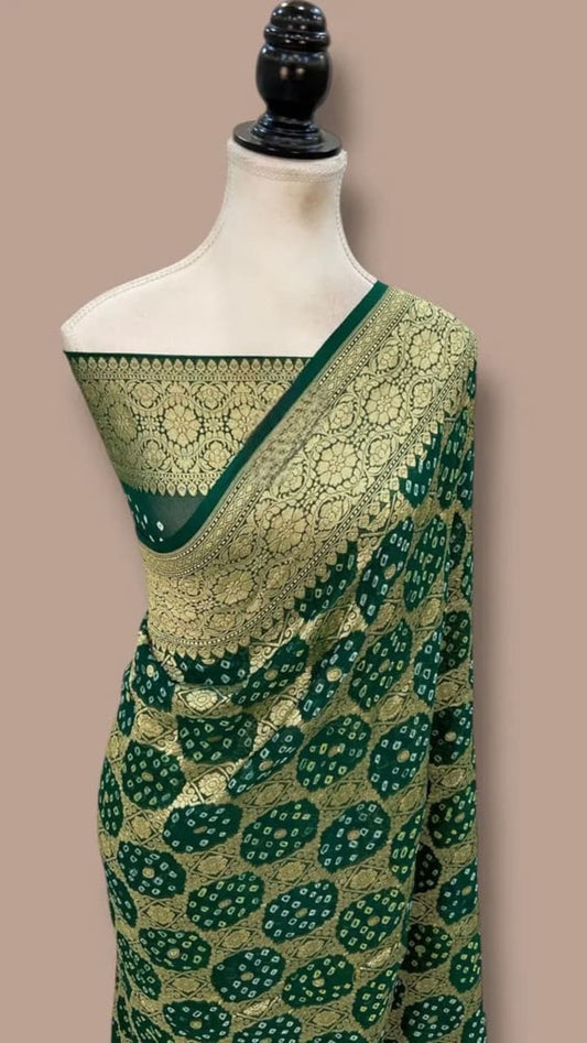 Green saree with gold pallu border and scattered circular dot motifs, draped over shoulder