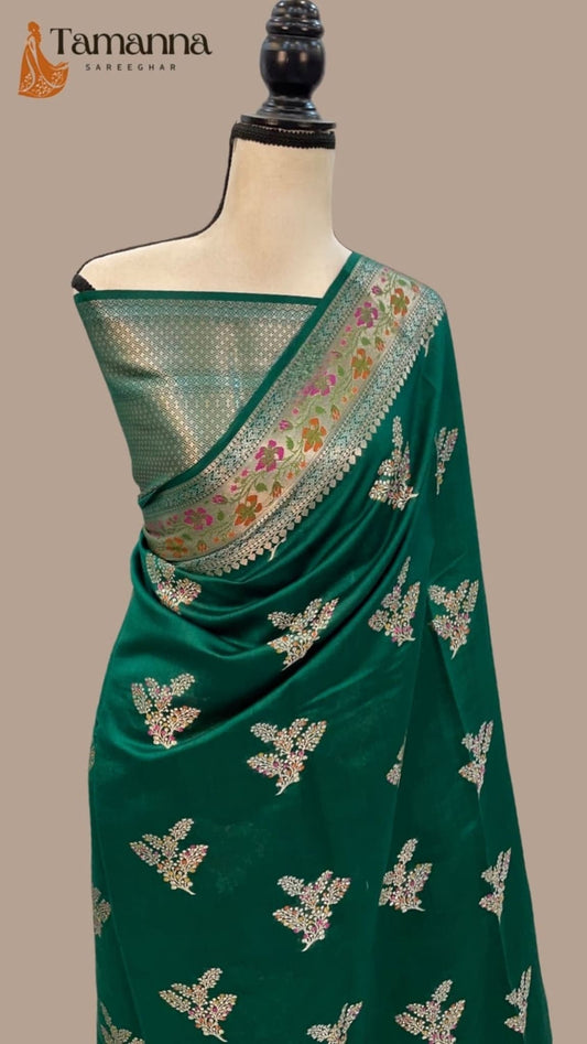 Green silk saree with gold leaf motifs and floral pallu border with gold edging