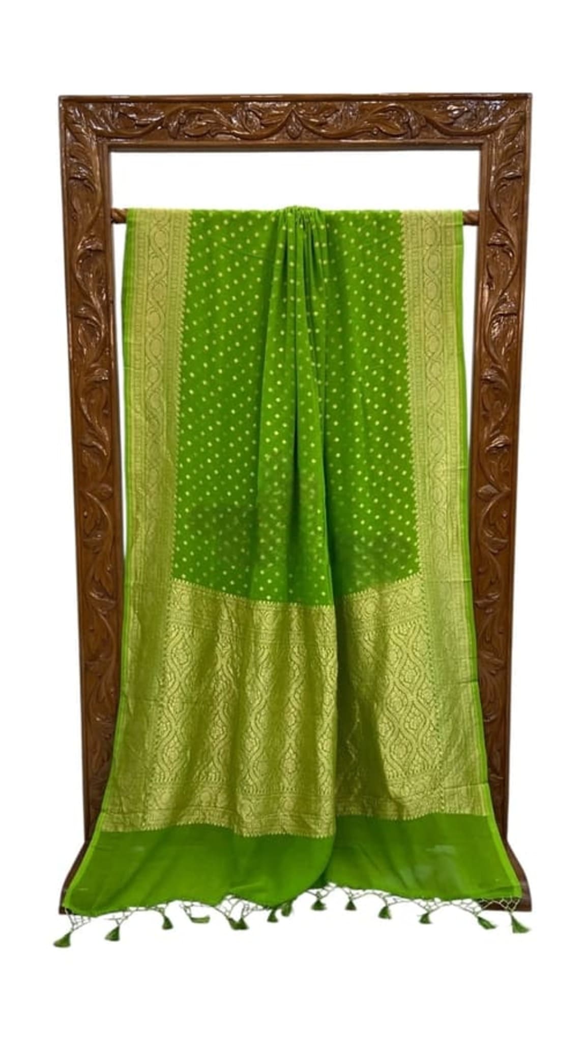 Green saree hanging with gold zari border and tassel fringe