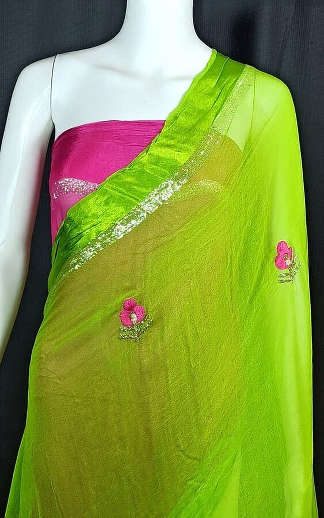 Green georgette saree with shimmering zari band and pink floral motif