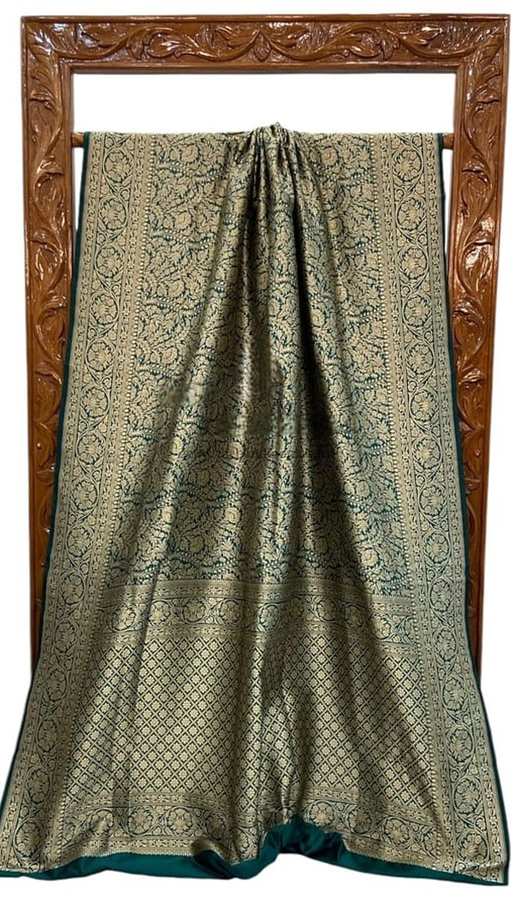 Green silk saree with gathered top, gold brocade motifs, and teal border, laid flat