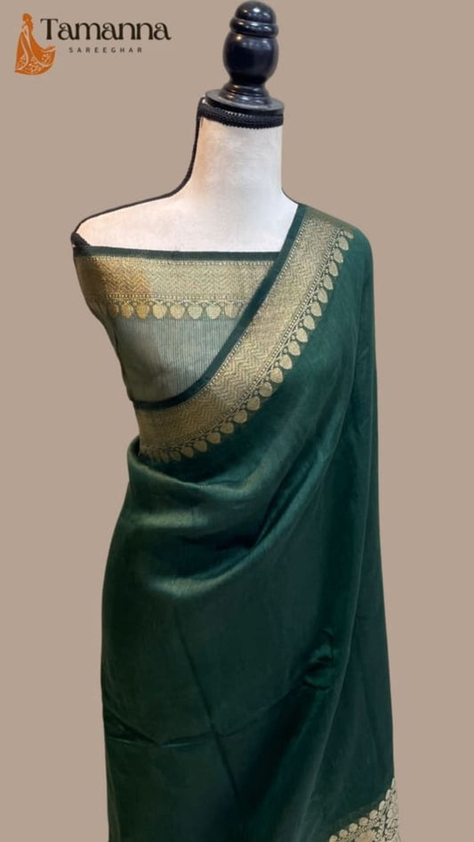 Green linen saree on mannequin with gold-trimmed pallu and woven stripe border