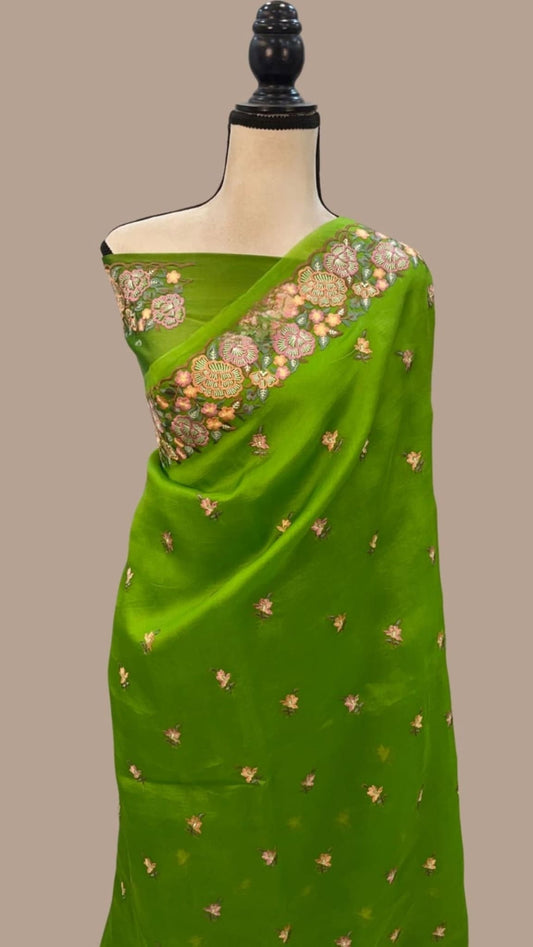 Green organza Banarasi saree with floral pallu and dotted sprig motifs