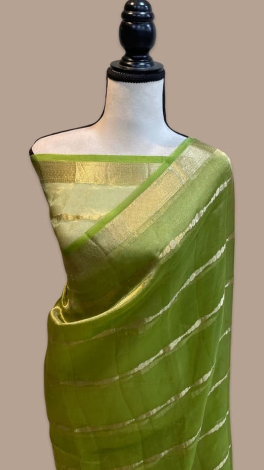 Green tissue saree with gold pallu and green border on drape