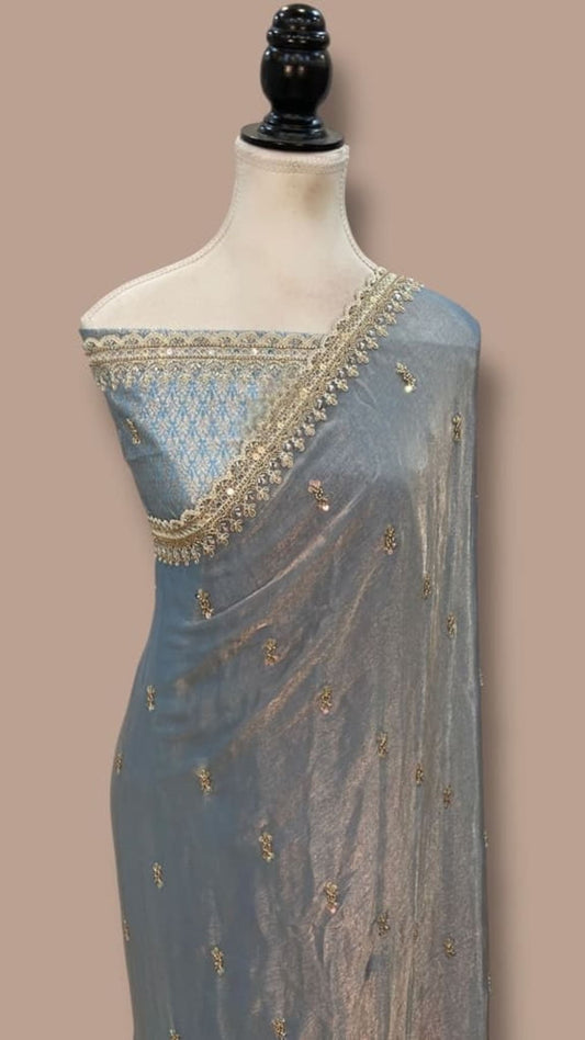 Georgette saree on mannequin, gold-trimmed pallu with scattered motifs