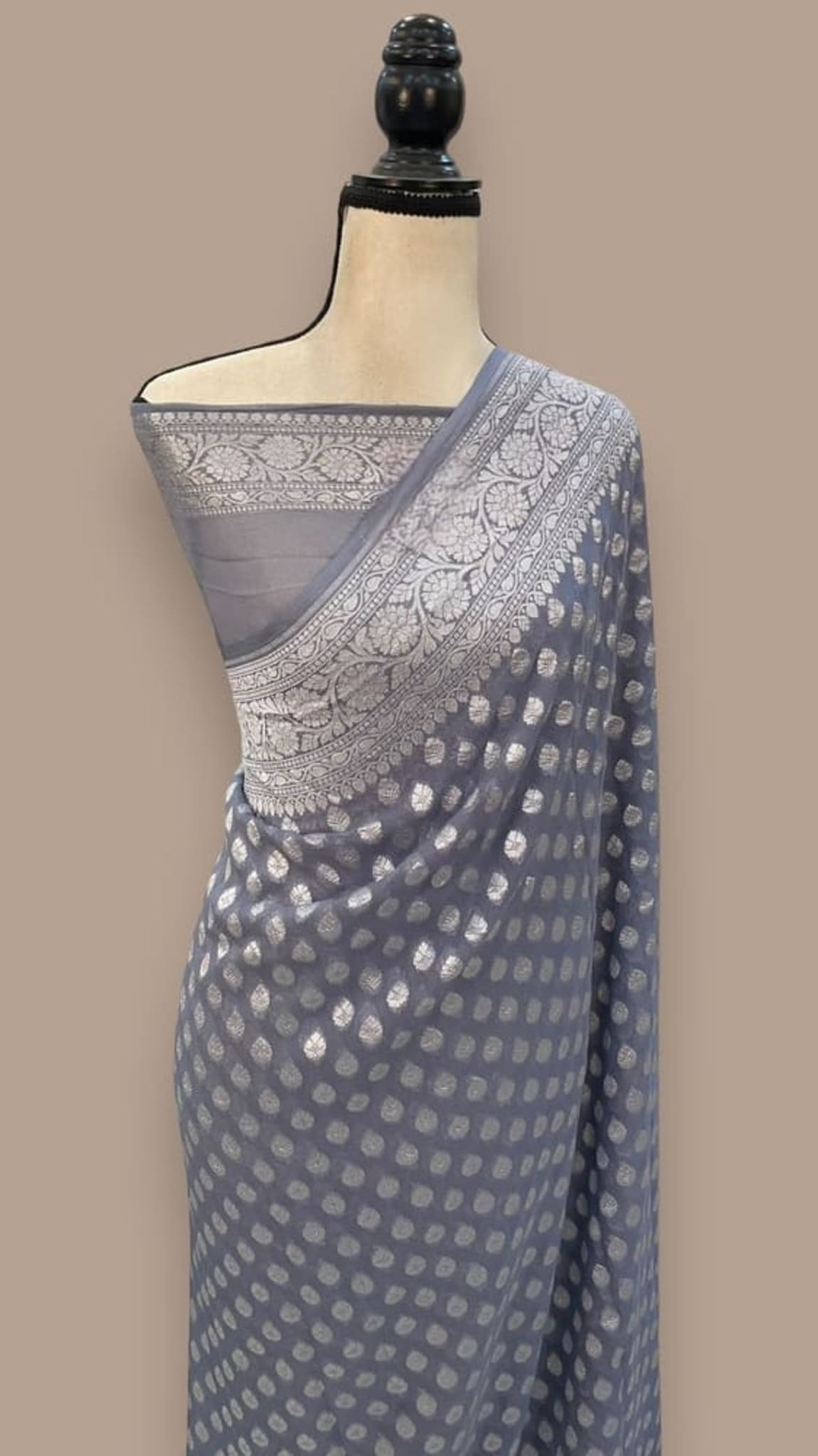 Draped blue georgette saree with silver border and dotted pallu motif