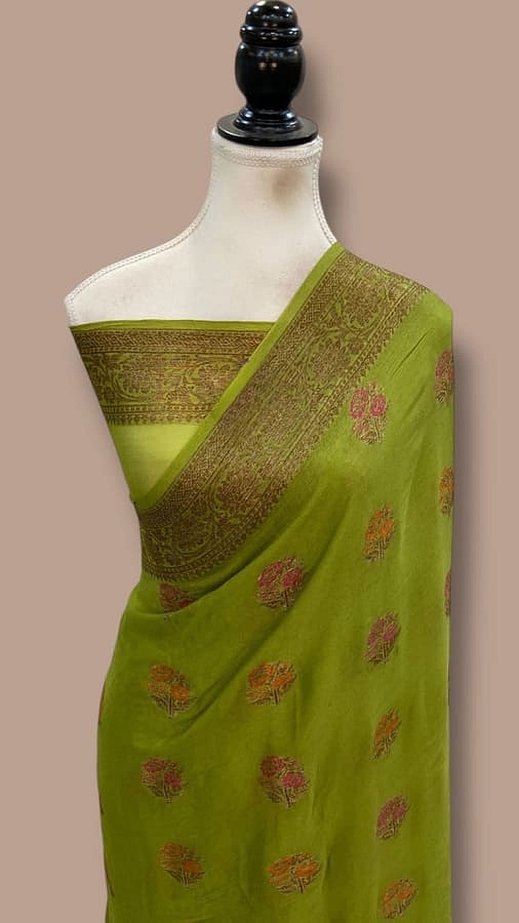 Lime green saree with gold-trimmed border and pink floral motifs