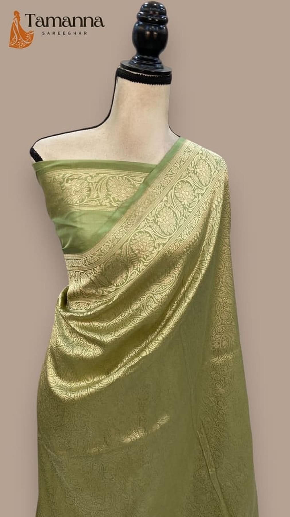 Green silk saree on mannequin, patterned pallu with decorative woven border