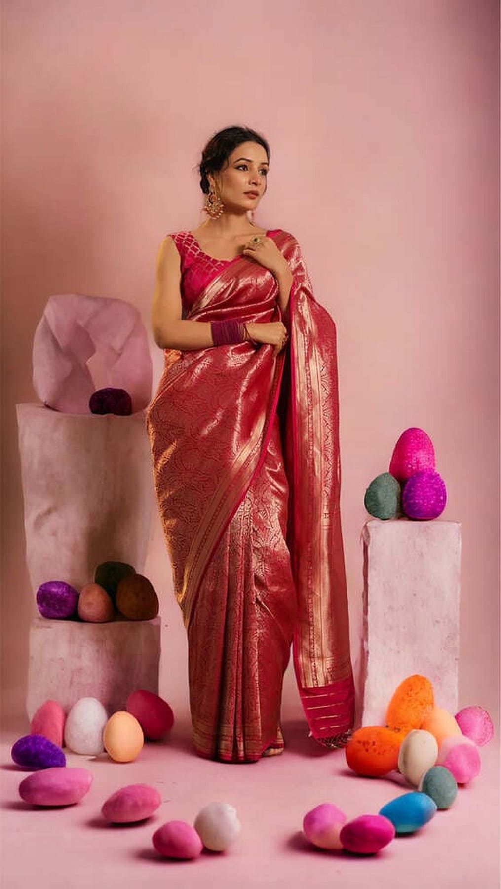 Hot pink Banarasi silk saree with gold border and sheen, full-length standing