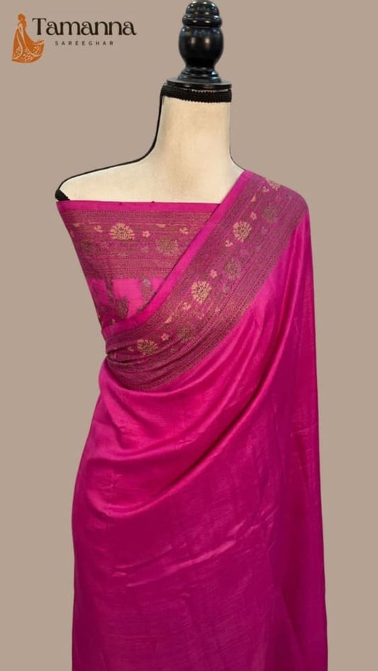 Hot pink saree with gold pallu border featuring small woven motifs on mannequin