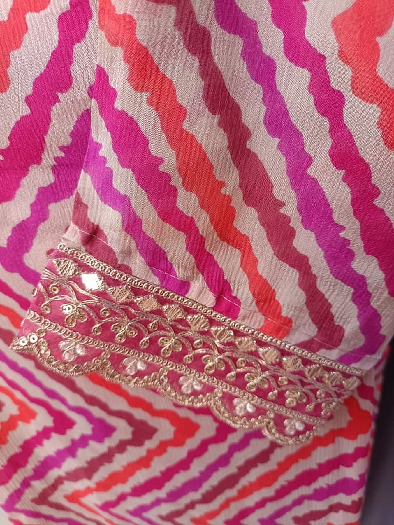 Gold embroidered hem on zigzag pink-and-cream striped dupatta edge