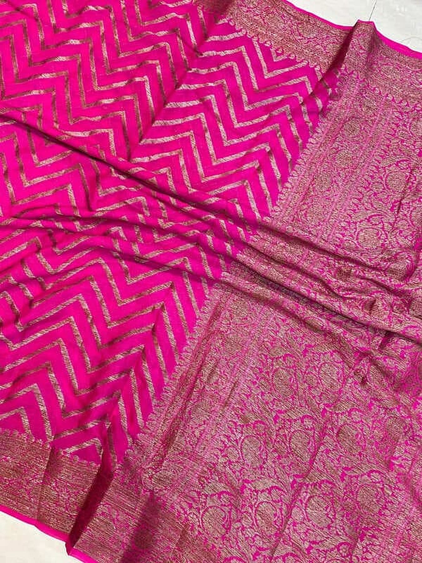 Hot pink chiffon saree close-up of gold zigzag design and brocade floral panel