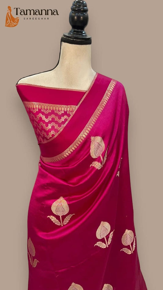 Hot pink silk Banarasi saree pallu on mannequin, gold zari edge and leaf motifs
