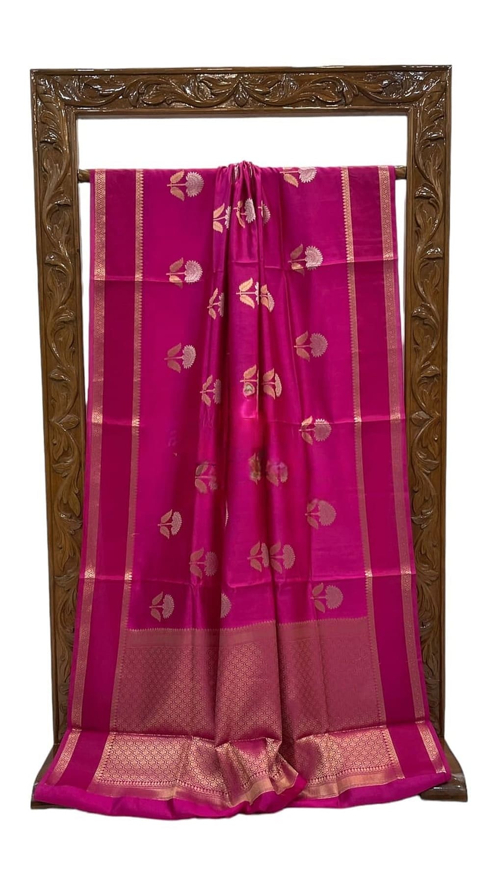 Hot pink silk saree front view with gold stripes, allover woven motifs, and ornate border