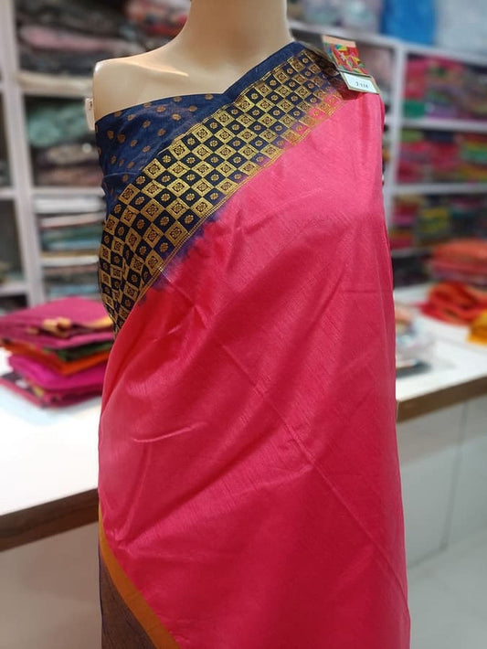 Hot pink silk saree with navy patterned border, pleated drape on mannequin