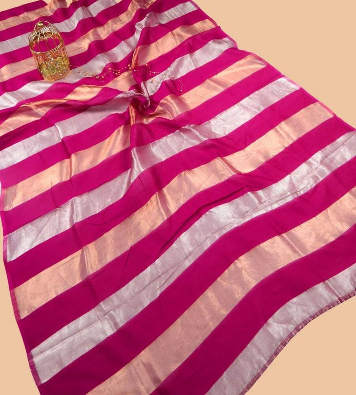 Hot pink striped tissue saree with silver zari bands and pleated pallu