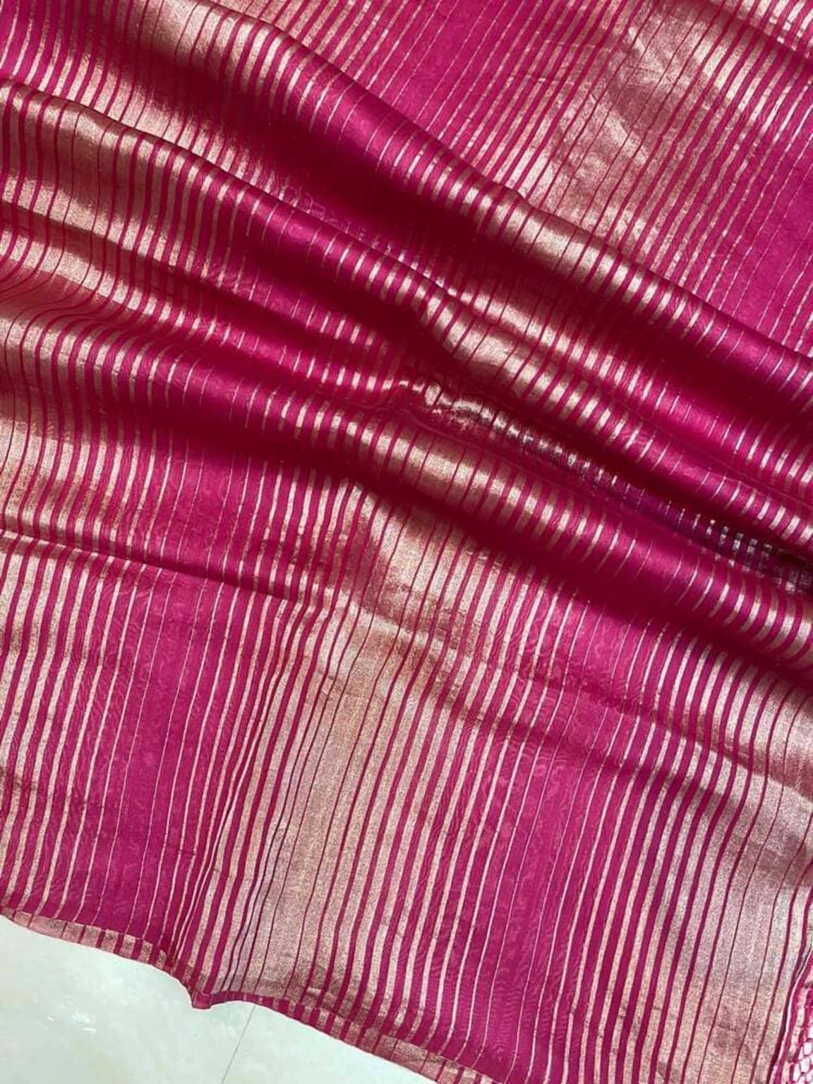 Hot pink tissue border with metallic silver-gold parallel stripes and texture