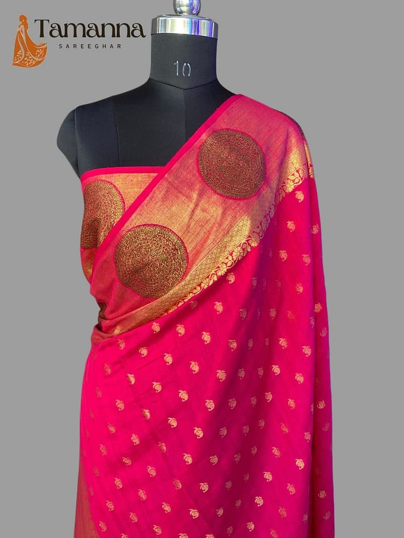 Pink silk saree with gold zari pallu, circular motifs, and small pattern