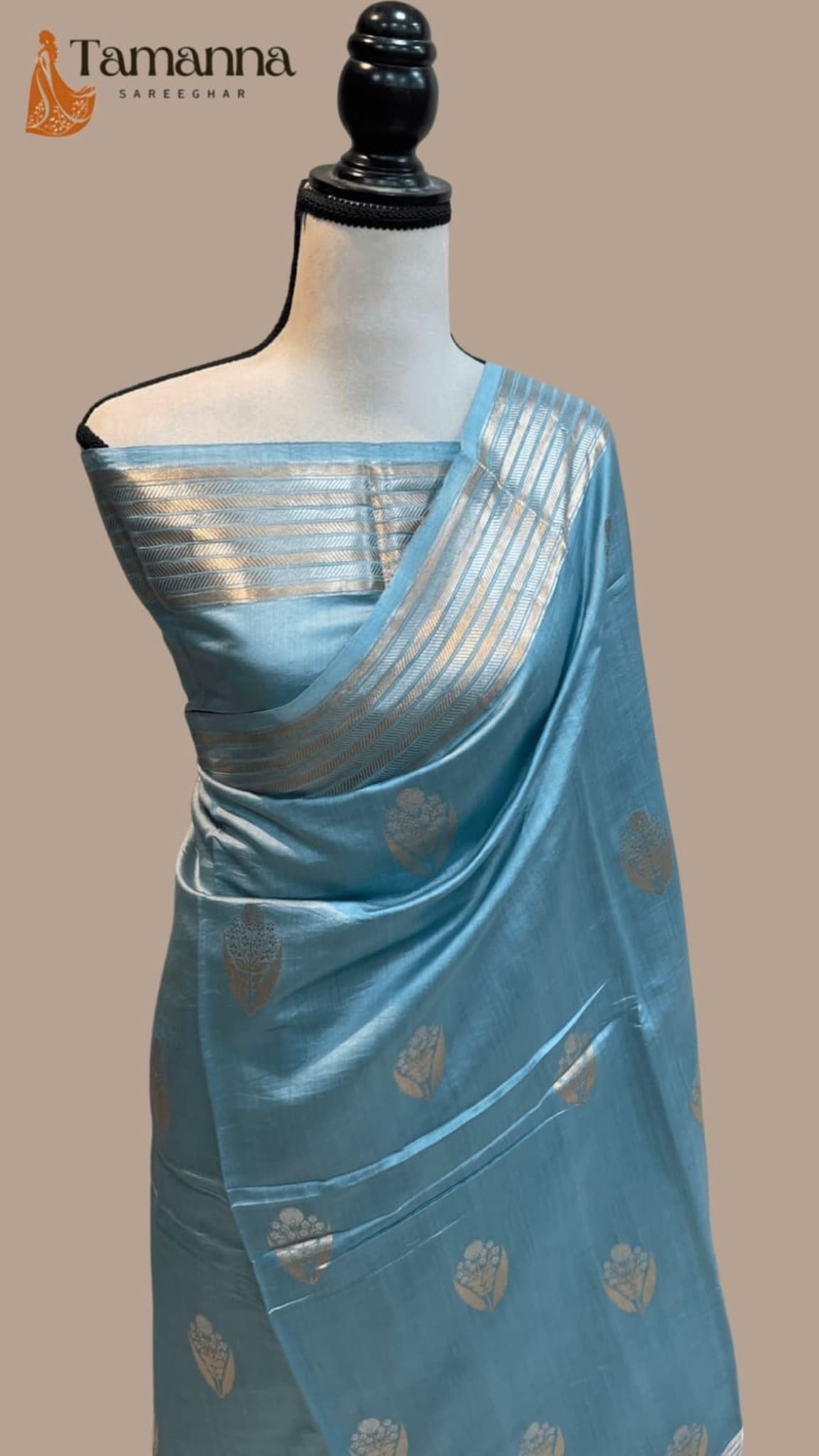 Ice blue silk saree with gold leaf prints and narrow striped zari border