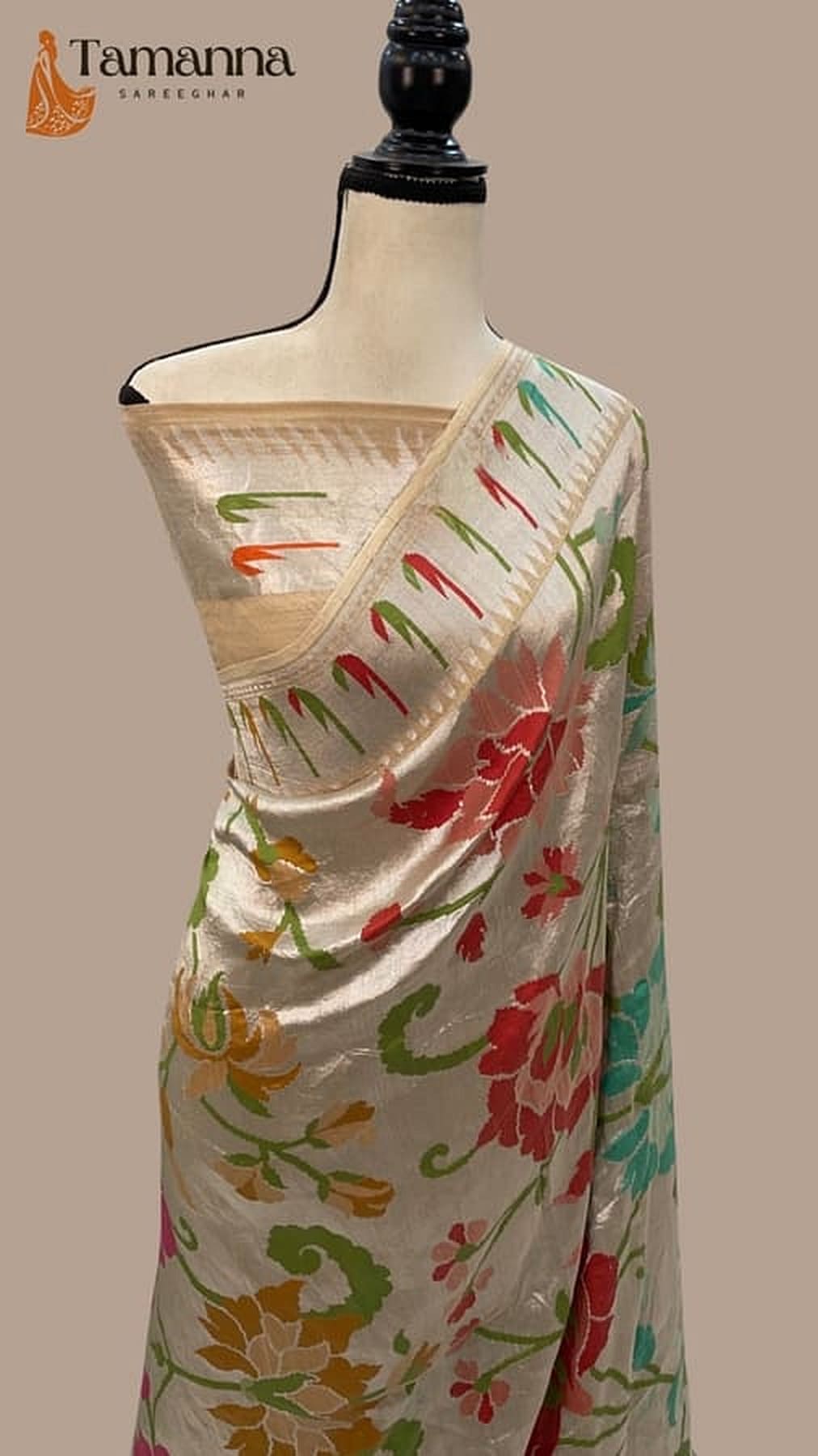 Ivory draped saree on mannequin with colorful floral vine print and pallu border