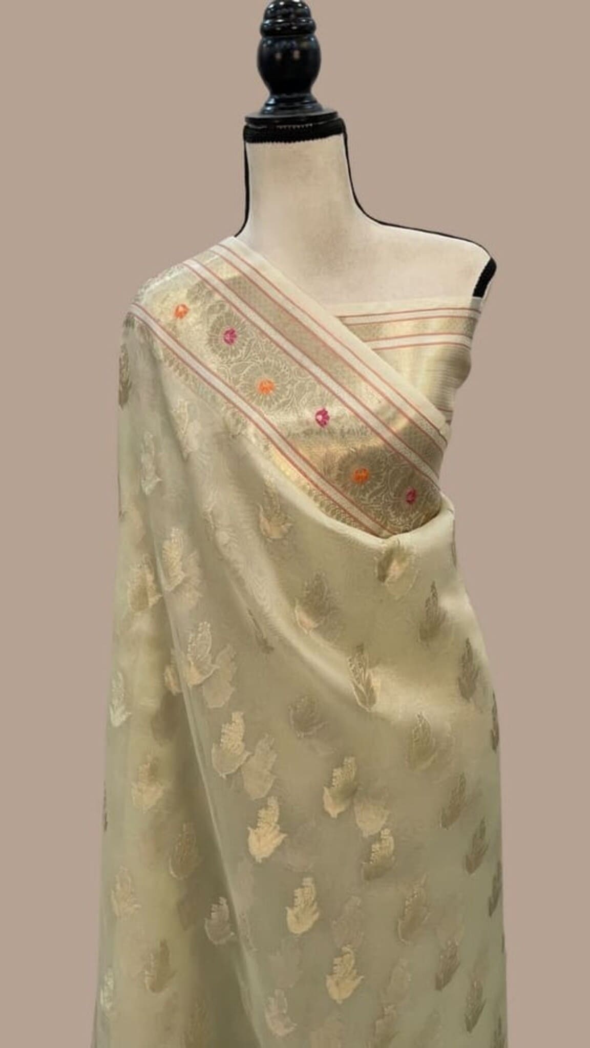 Ivory Banarasi saree on mannequin, gold weave with multicolor striped border