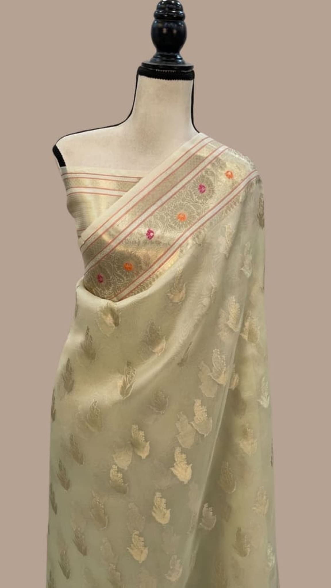 Ivory Banarasi saree with gold-tone weave, multicolor motif border and pallu