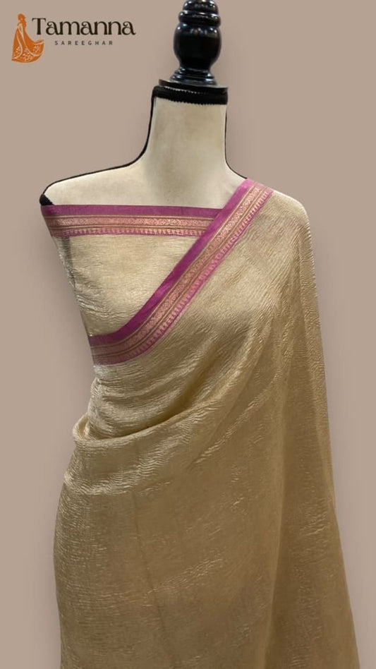 Ivory saree with magenta-purple border and striped woven trim, draped on mannequin