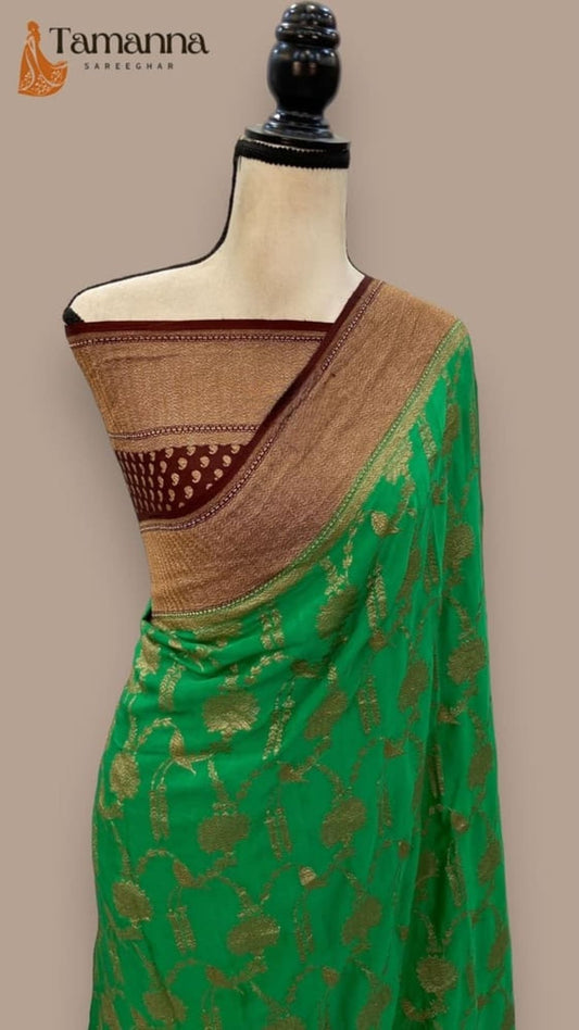 Jade-green Banarasi saree draped on mannequin with antique zari pallu and gold trim