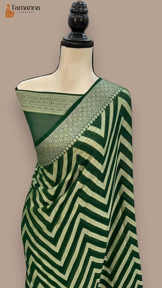 Khaddi chiffon Banarasi saree draped on mannequin in deep green zigzag chevron with gold border